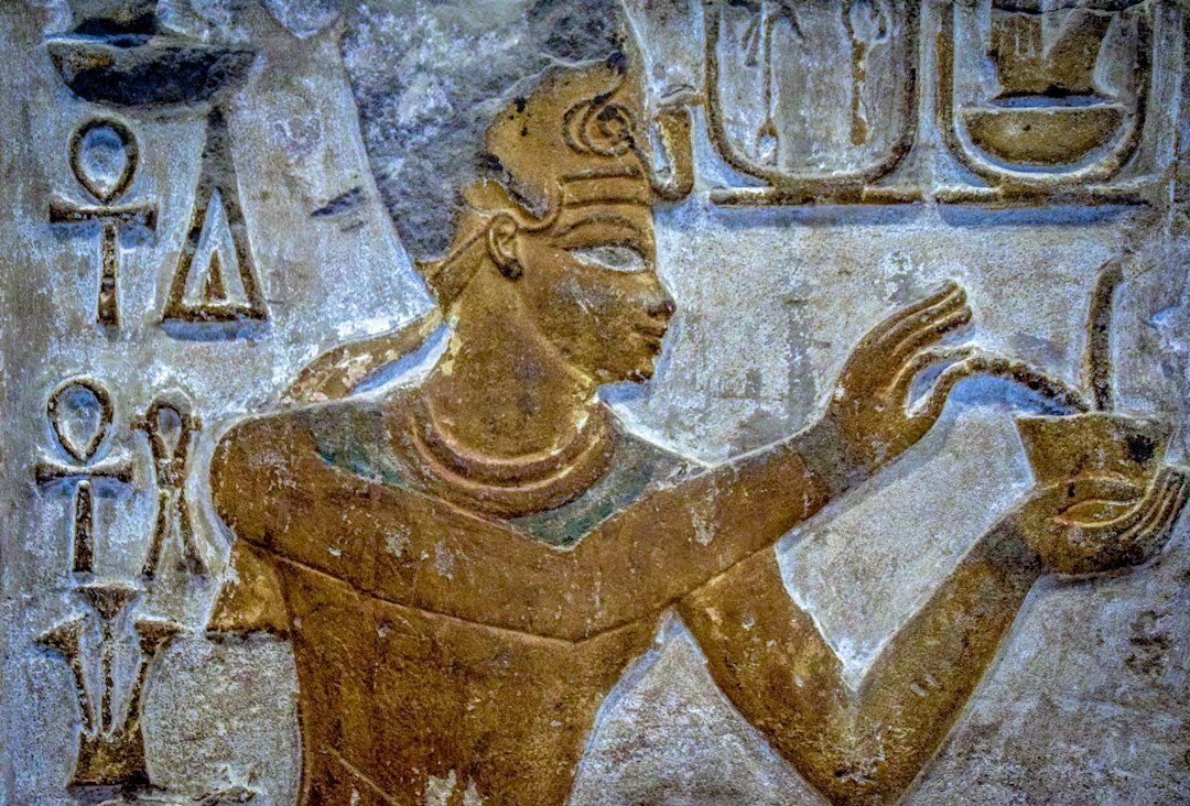 Close-up detail of ancient Egyptian carved reliefs illustrating temple art and royal inscriptions