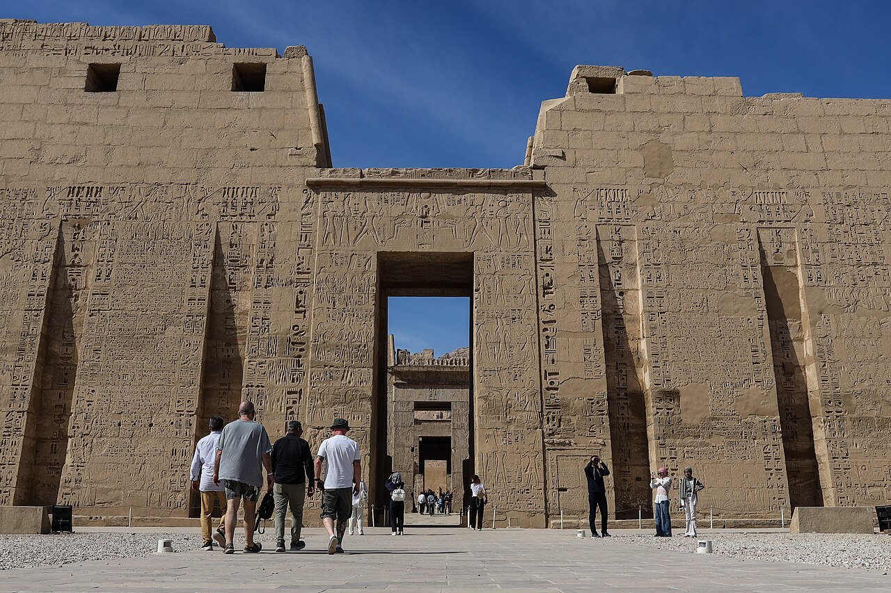 Wide view of the colored reliefs and monumental architecture of Medinet Habu, the temple of Ramesses III in Luxor